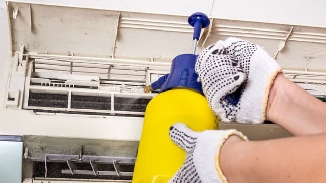 technician-spraying-chemical-water-onto-air
